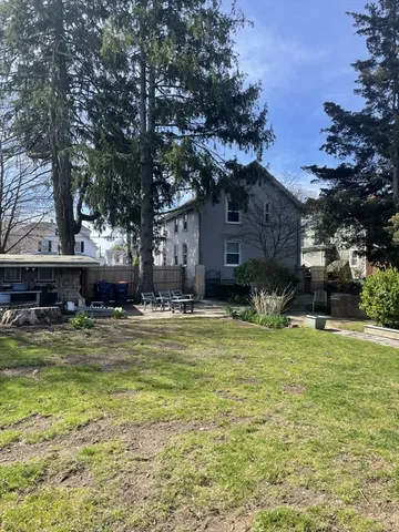 a view of a house with pool and a garden