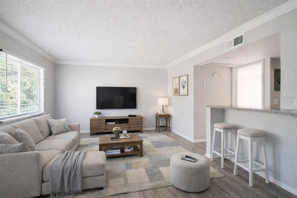 129 Blue Pointe Way, Unit 340 Altamonte Springs, FL 32701 - Photo 4 of 25 a living room with furniture and a flat screen tv
