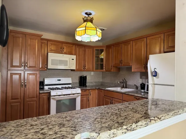 a kitchen with a stove a sink and a microwave