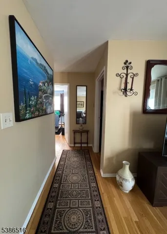 a bathroom with a sink a toilet a mirror a vanity and bathtub