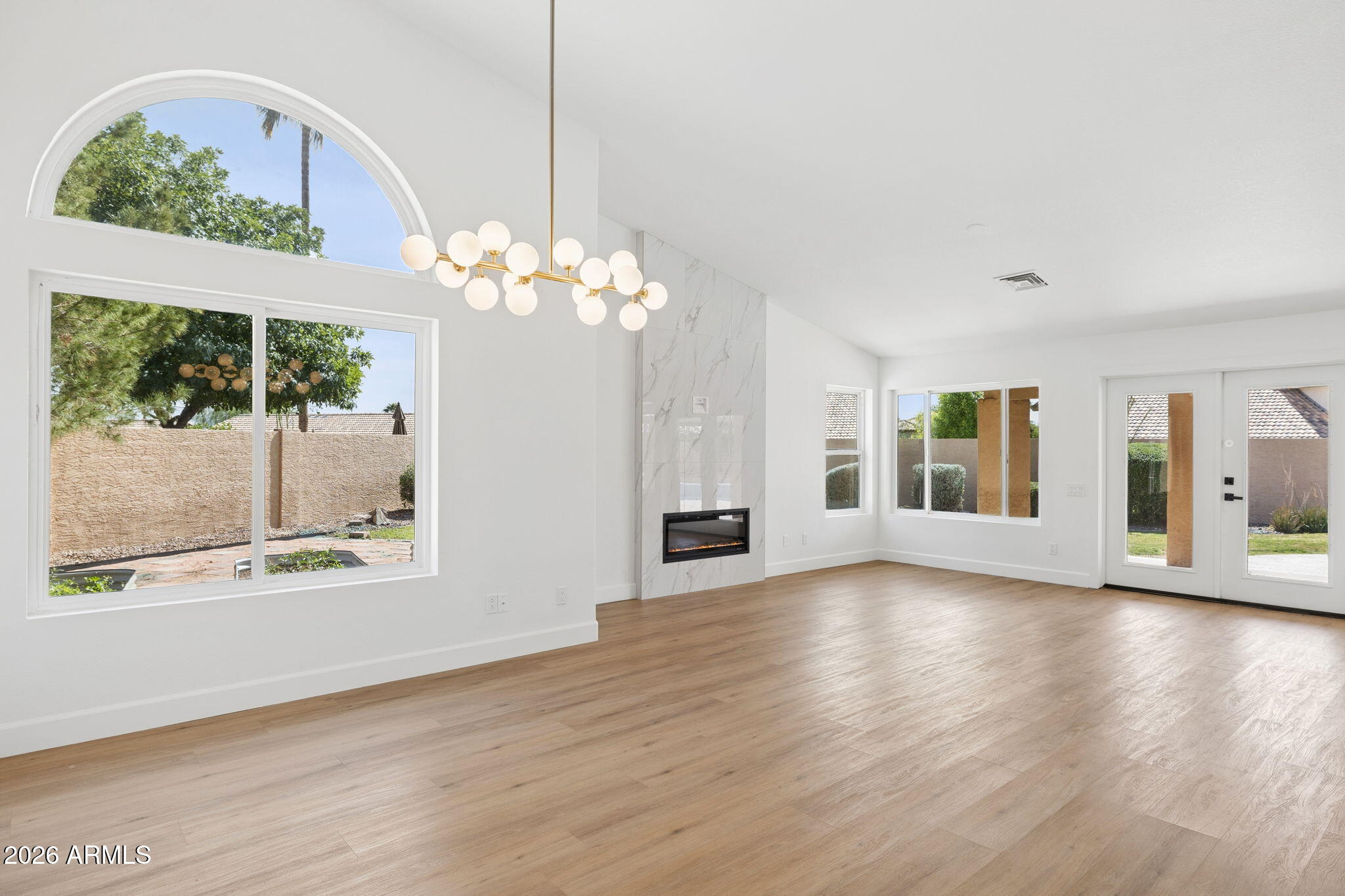 2451 East Dry Creek Road Phoenix, AZ 85048 - Photo 10 of 56 a view of an empty room with wooden floor and a window