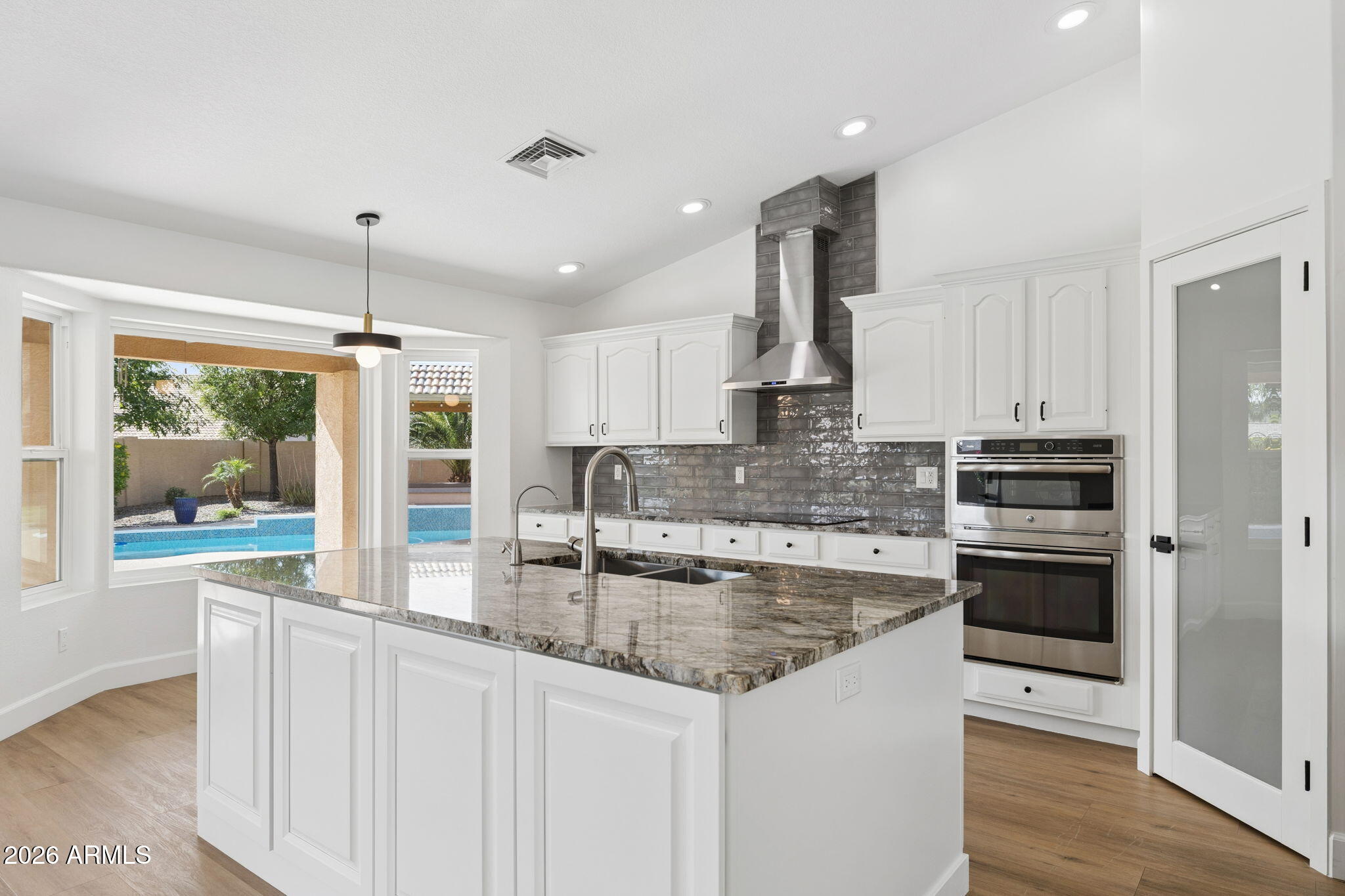 2451 East Dry Creek Road Phoenix, AZ 85048 - Photo 12 of 56 a kitchen with stainless steel appliances granite countertop a stove and a sink
