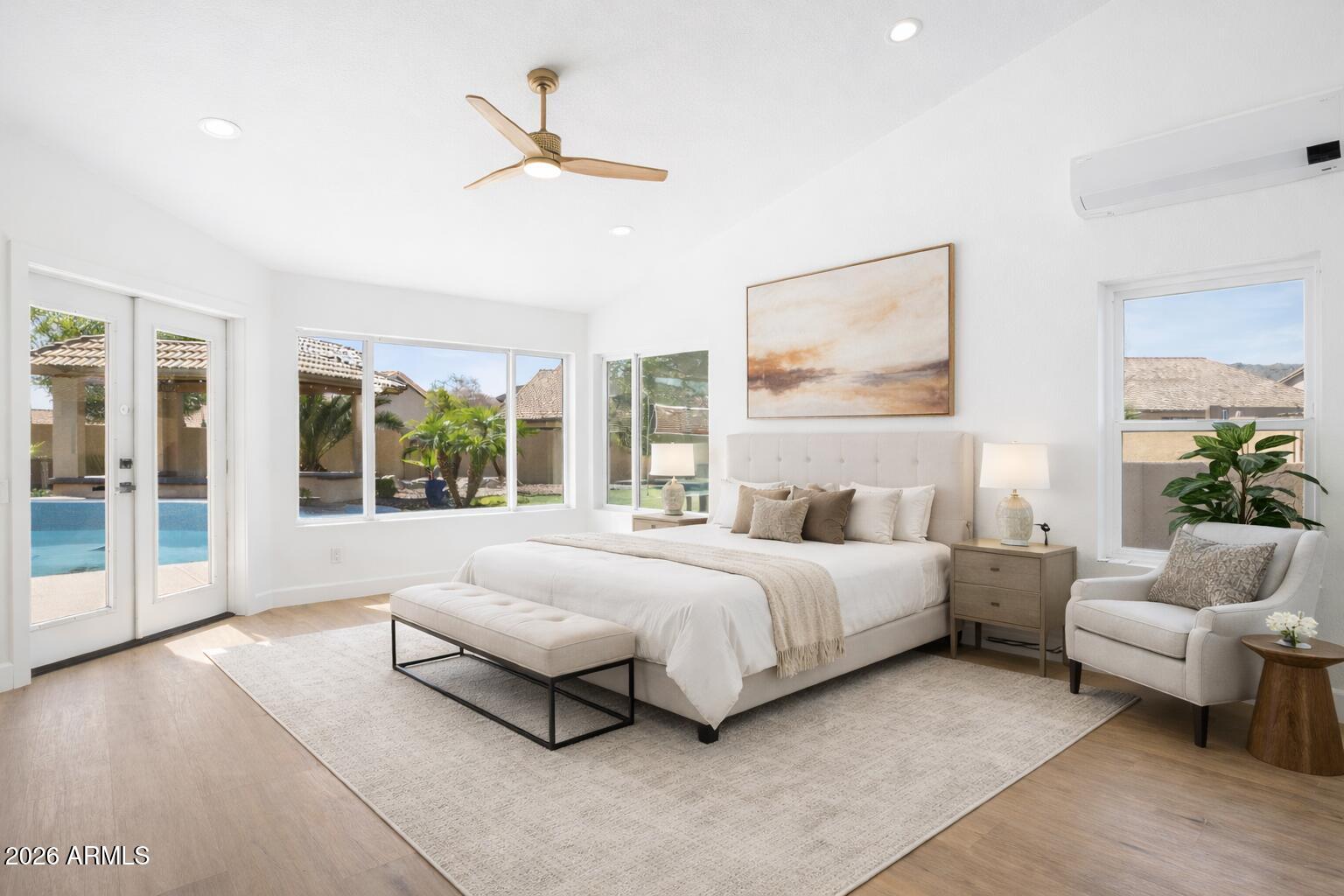 2451 East Dry Creek Road Phoenix, AZ 85048 - Photo 18 of 56 a spacious bedroom with a large bed and a couch