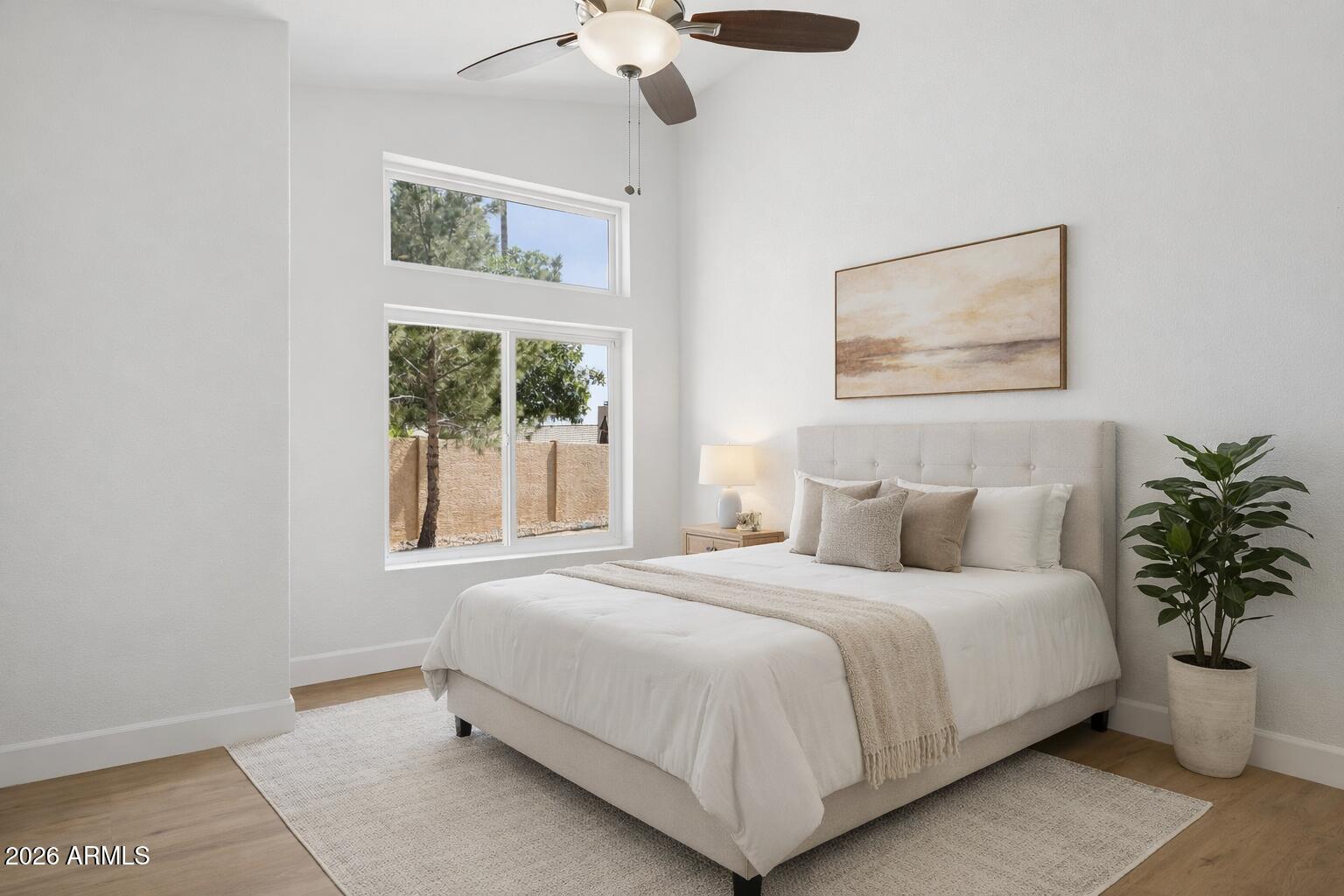 2451 East Dry Creek Road Phoenix, AZ 85048 - Photo 26 of 56 a bedroom with a bed lamp and window