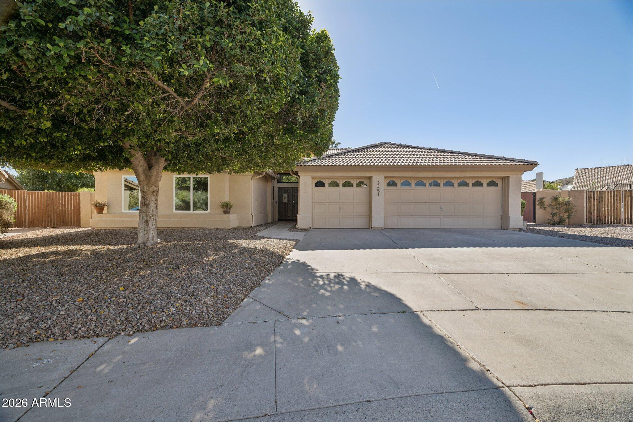 2451 East Dry Creek Road Phoenix, AZ 85048 - Photo 2 of 56 a front view of a house with a garden