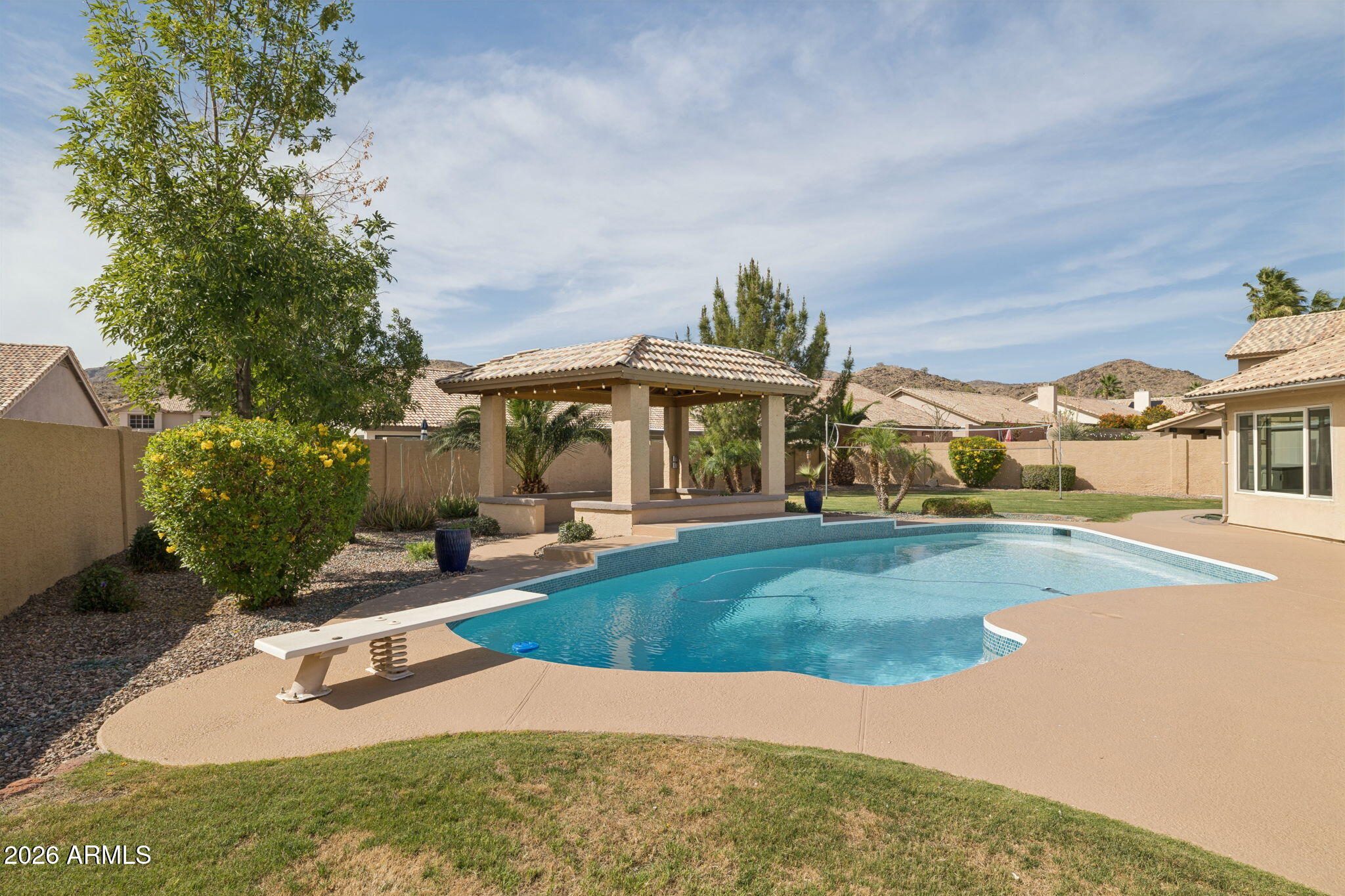 2451 East Dry Creek Road Phoenix, AZ 85048 - Photo 36 of 56 a view of a house with swimming pool and sitting area