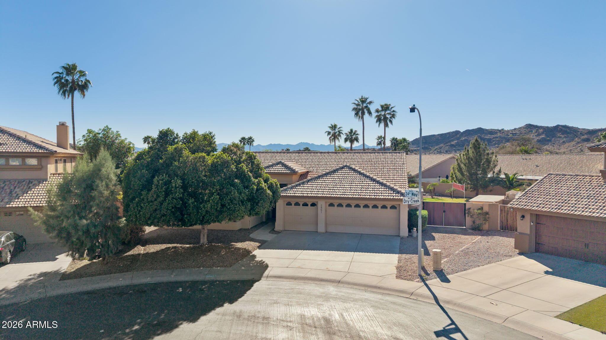 2451 East Dry Creek Road Phoenix, AZ 85048 - Photo 47 of 56 a front view of a house with a garden