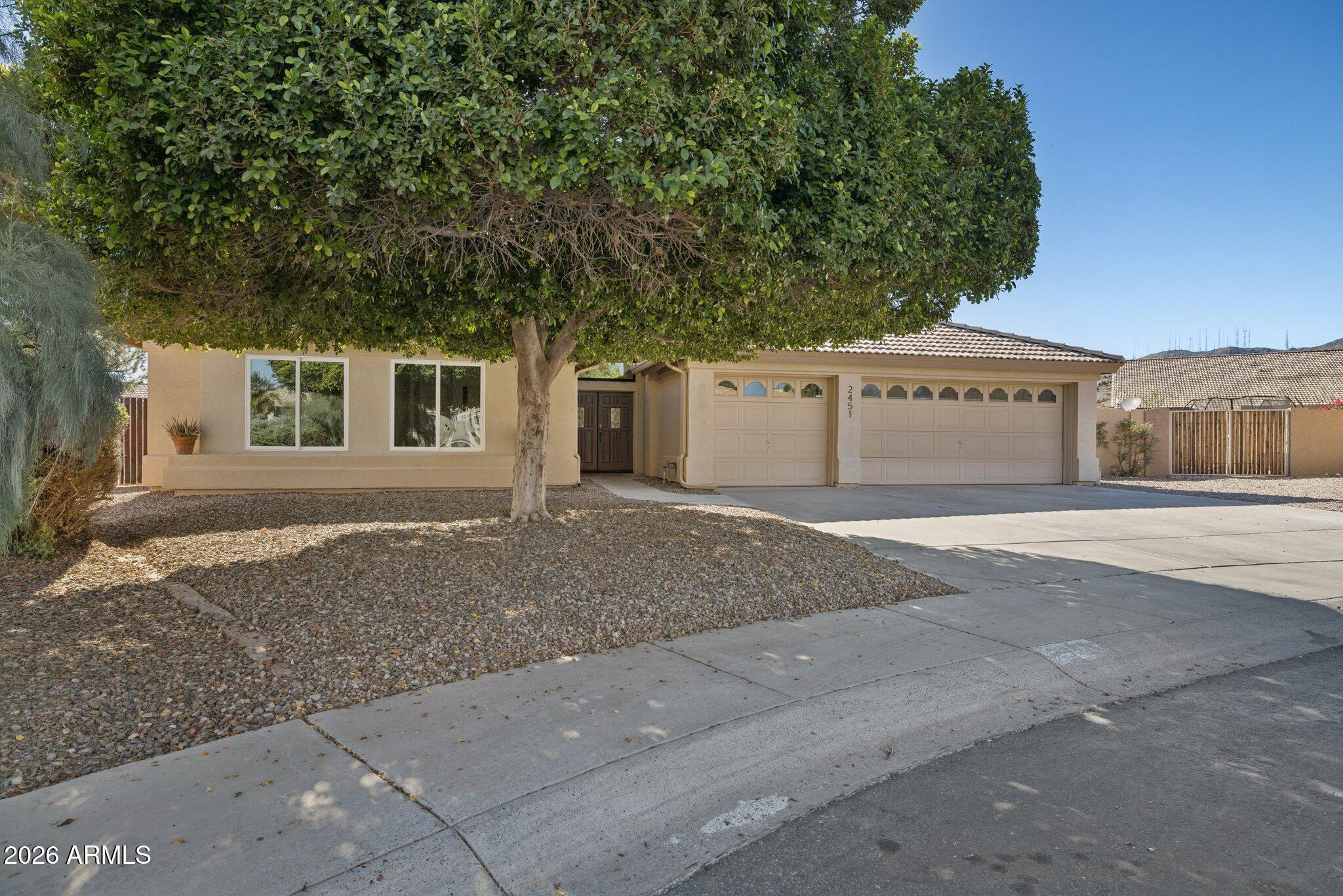 2451 East Dry Creek Road Phoenix, AZ 85048 - Photo 3 of 56 a front view of a house with a yard and garage