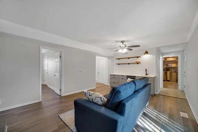 a living room with furniture and a chandelier