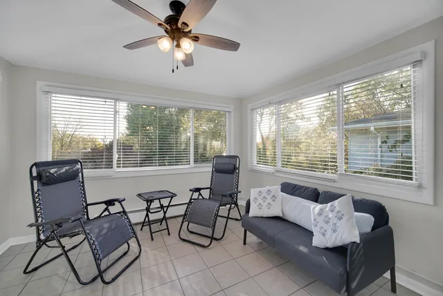 a living room with furniture and floor to ceiling windows
