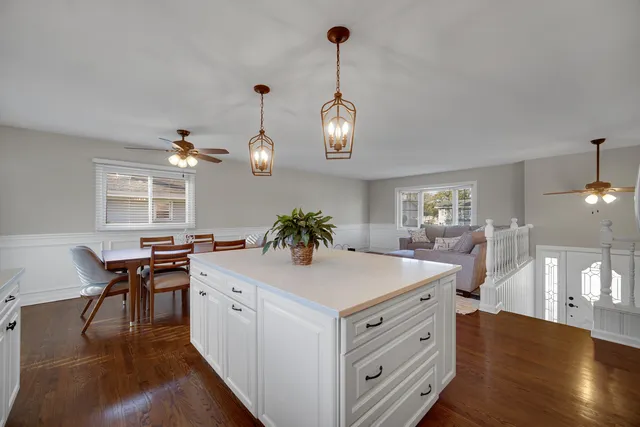 a view of living room kitchen island furniture and wooden floor