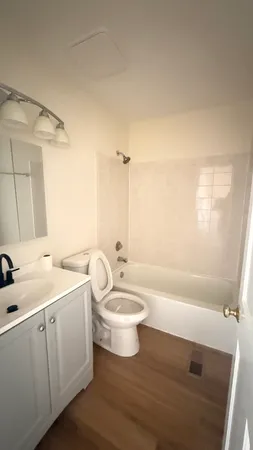 a bathroom with a double vanity sink toilet a mirror and shower