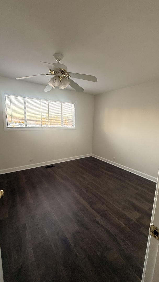 604 Bayview Point, Unit 604 Schaumburg, IL 60194 - Photo 13 of 17 an empty room with wooden floor and windows