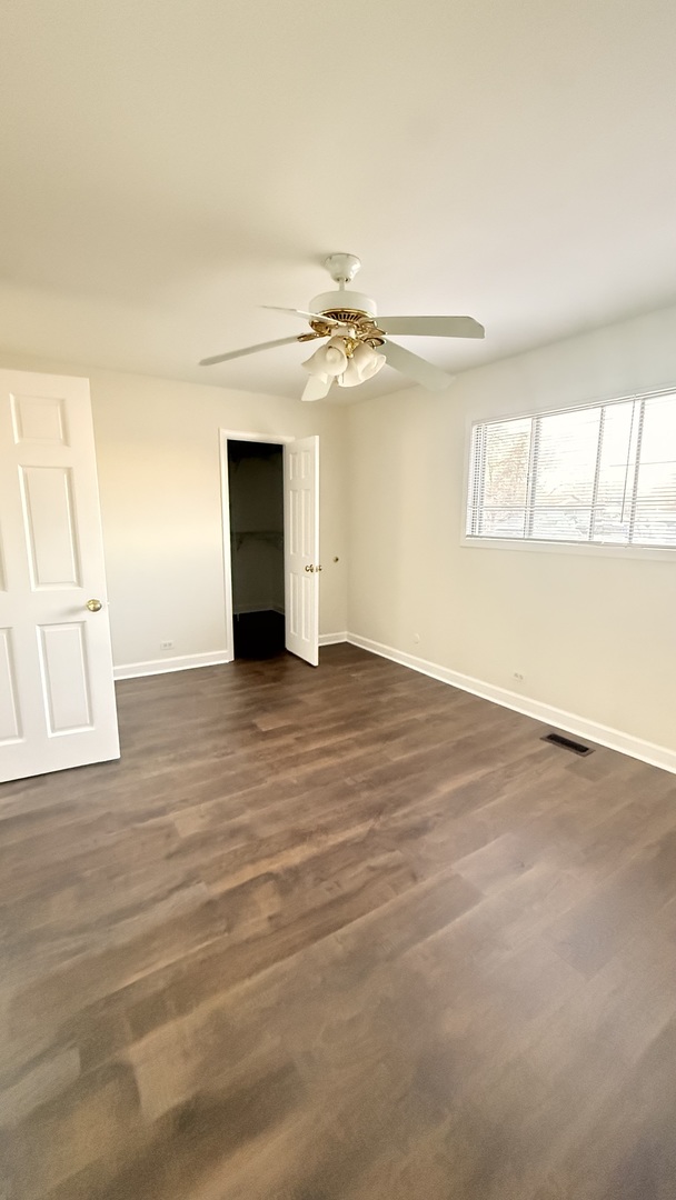 604 Bayview Point, Unit 604 Schaumburg, IL 60194 - Photo 14 of 17 wooden floor in an empty room with a window