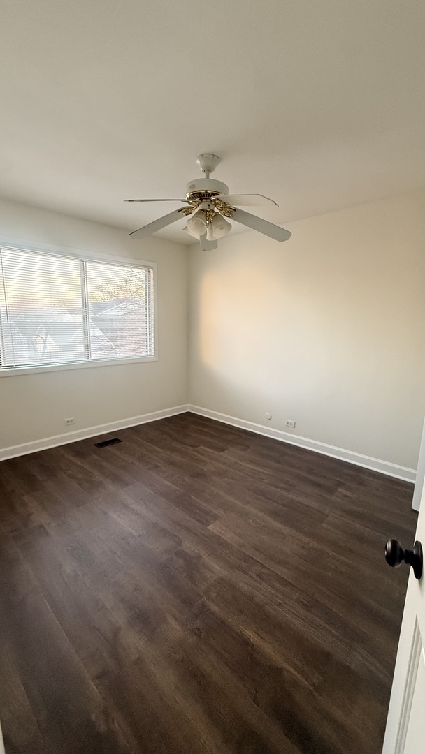 604 Bayview Point, Unit 604 Schaumburg, IL 60194 - Photo 15 of 17 an empty room with wooden floor fan and windows
