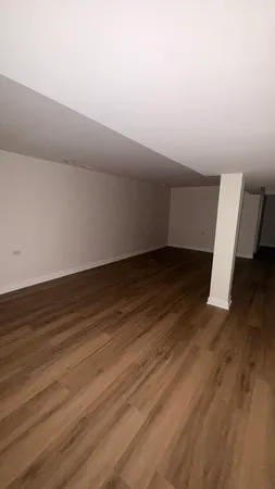 a view of wooden floor in an empty room