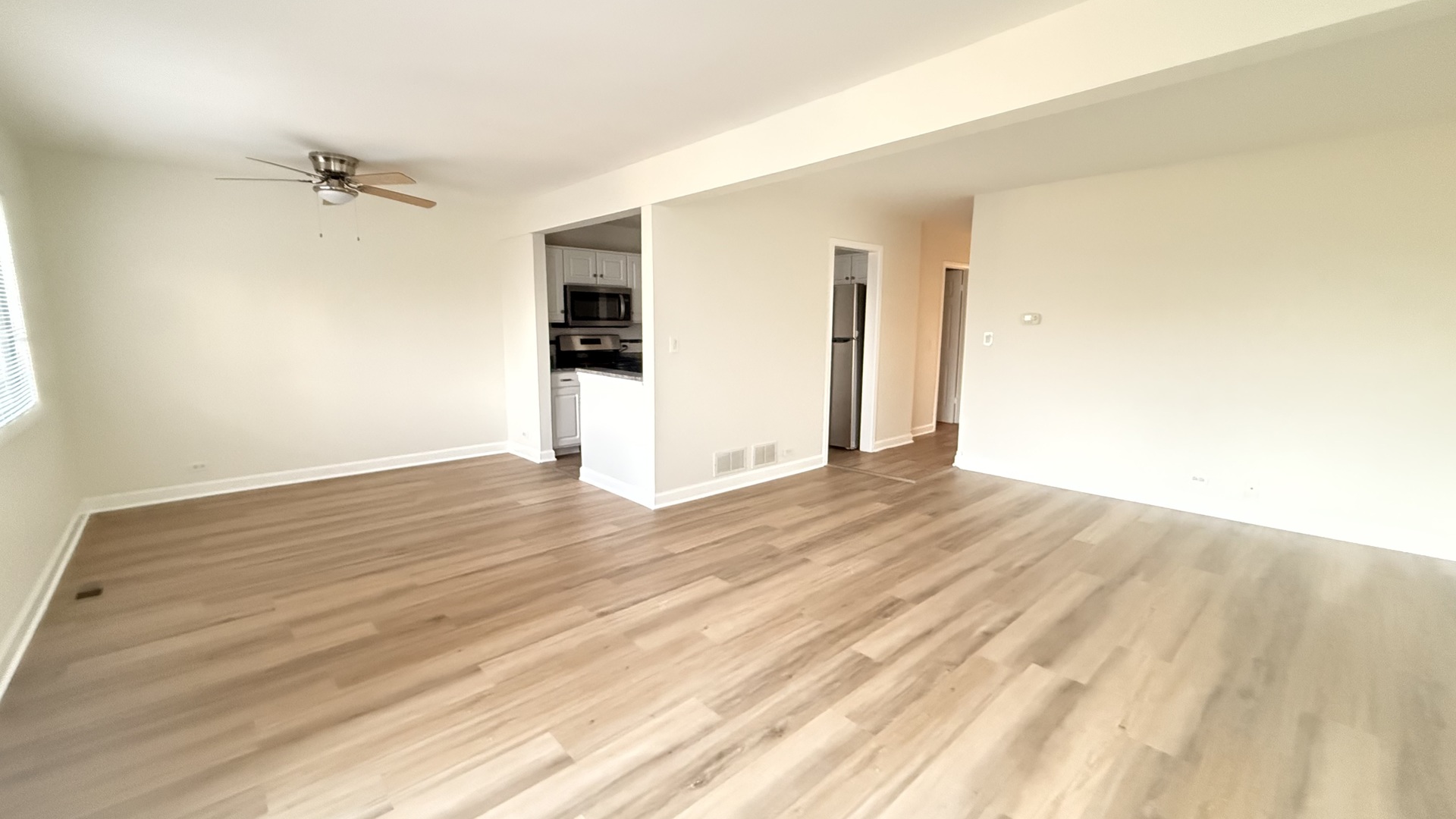 604 Bayview Point, Unit 604 Schaumburg, IL 60194 - Photo 7 of 17 a view of empty room with wooden floor and fan