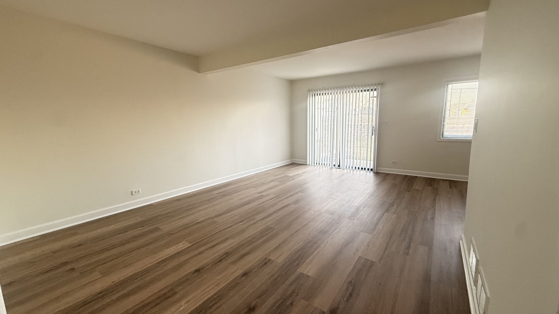 604 Bayview Point, Unit 604 Schaumburg, IL 60194 - Photo 8 of 17 a view of an empty room with wooden floor and a window