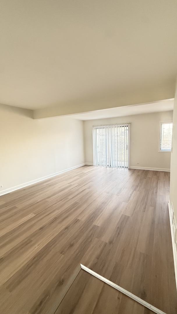 604 Bayview Point, Unit 604 Schaumburg, IL 60194 - Photo 9 of 17 wooden floor in an empty room with a window