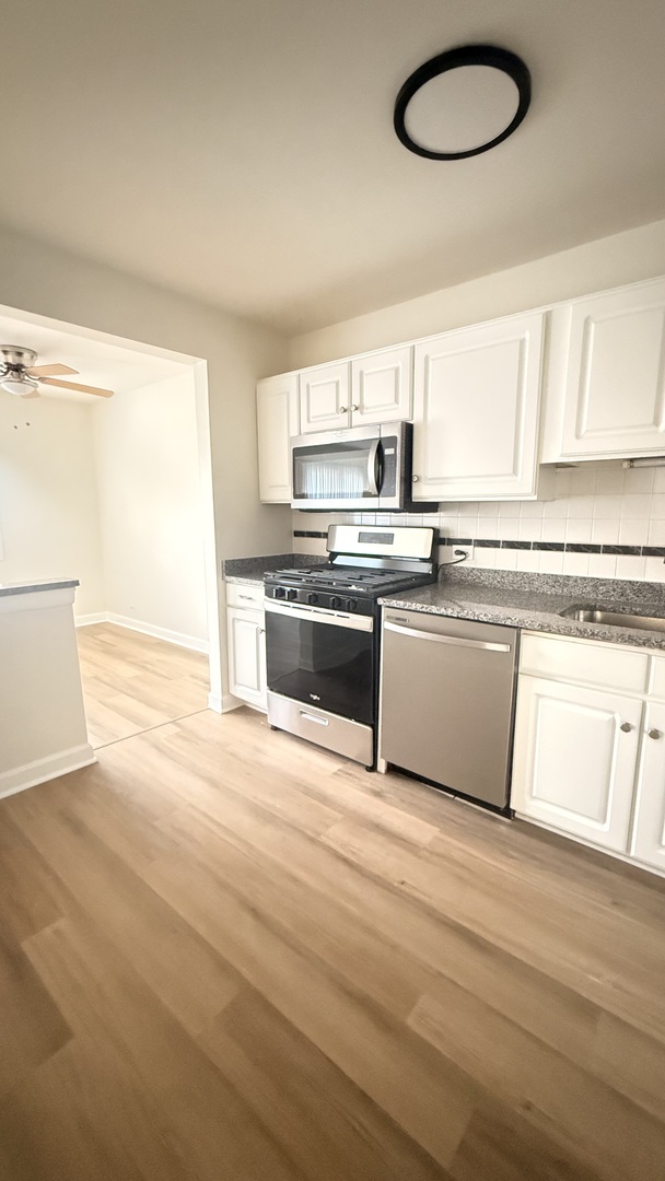 604 Bayview Point, Unit 604 Schaumburg, IL 60194 - Photo 10 of 17 a kitchen with stainless steel appliances granite countertop a stove a sink and a microwave