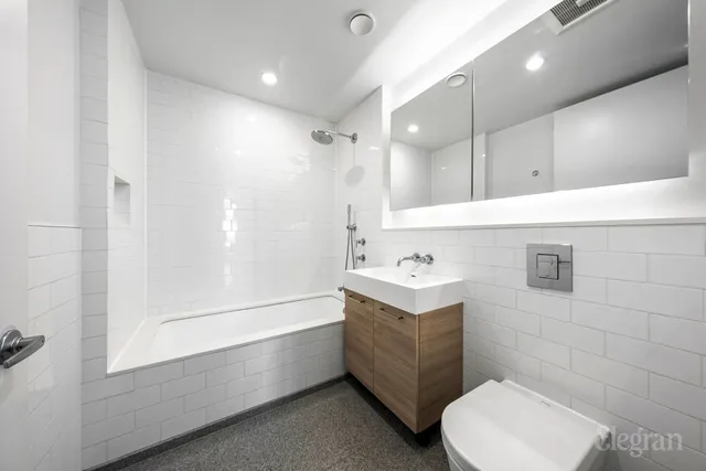 a bedroom with furniture and a flat screen tv