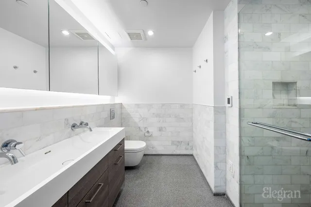 a bedroom with a large bed and a potted plant