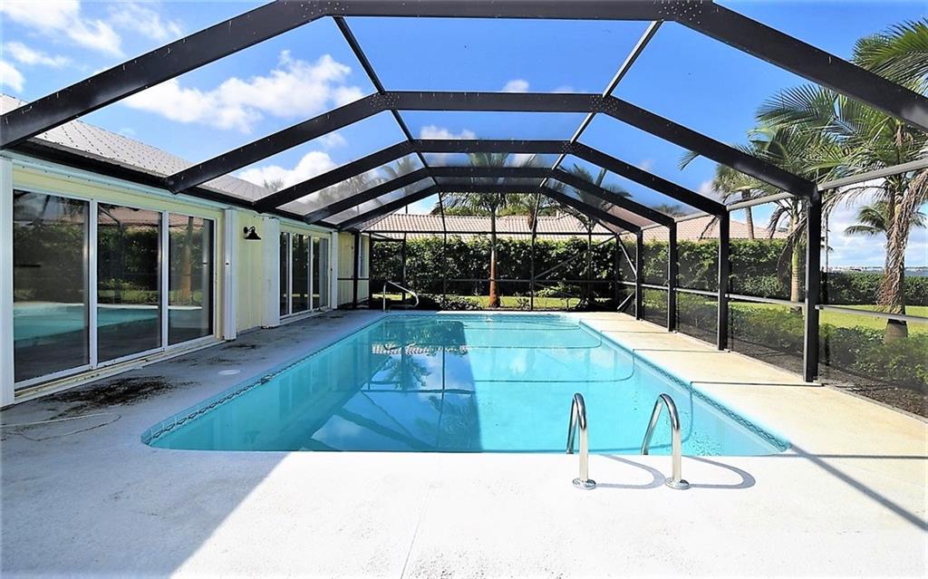 831 Southeast Riverside Drive Stuart, FL 34994 - Photo 27 of 36 a view of a swimming pool with a porch