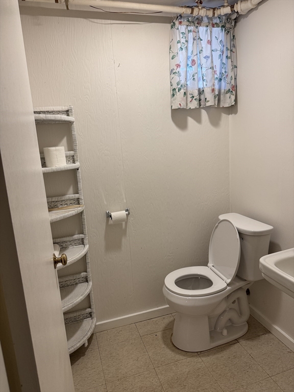 174 Forest Street Waltham, MA 02452 - Photo 12 of 15 a white toilet sitting next to a shower