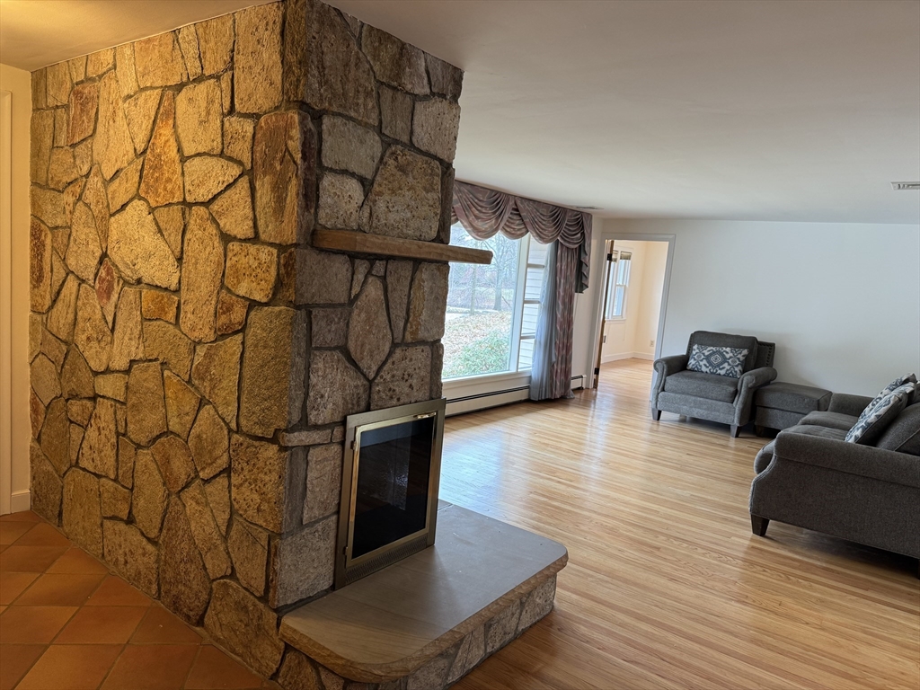 174 Forest Street Waltham, MA 02452 - Photo 2 of 15 a living room with couch and a table with wooden floor