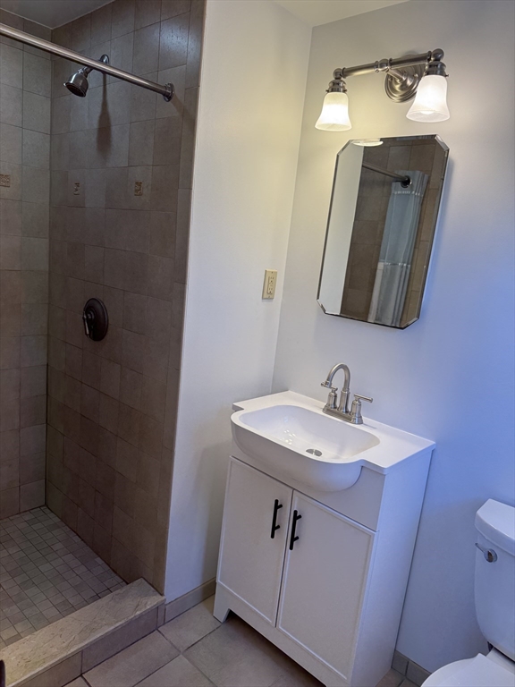 174 Forest Street Waltham, MA 02452 - Photo 4 of 15 a bathroom with a sink vanity mirror and toilet