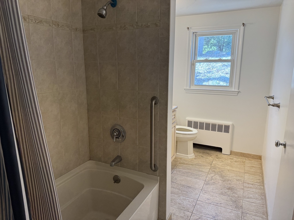 174 Forest Street Waltham, MA 02452 - Photo 7 of 15 a bathroom with a bathtub sink and toilet