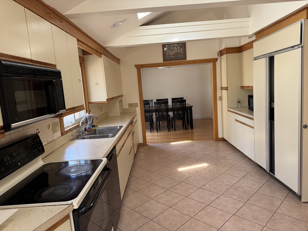 174 Forest Street Waltham, MA 02452 - Photo 8 of 15 a kitchen with stainless steel appliances a stove a sink and a microwave
