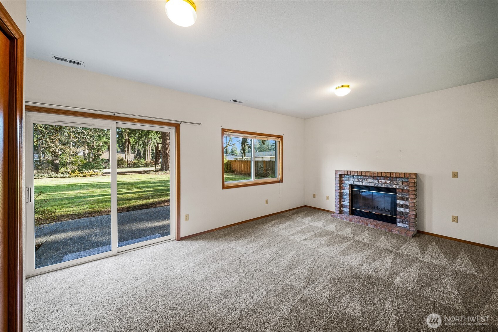 16011 Spanaway Loop Road South Spanaway, WA 98387 - Photo 12 of 35 an empty room with floor to ceiling windows and fireplace