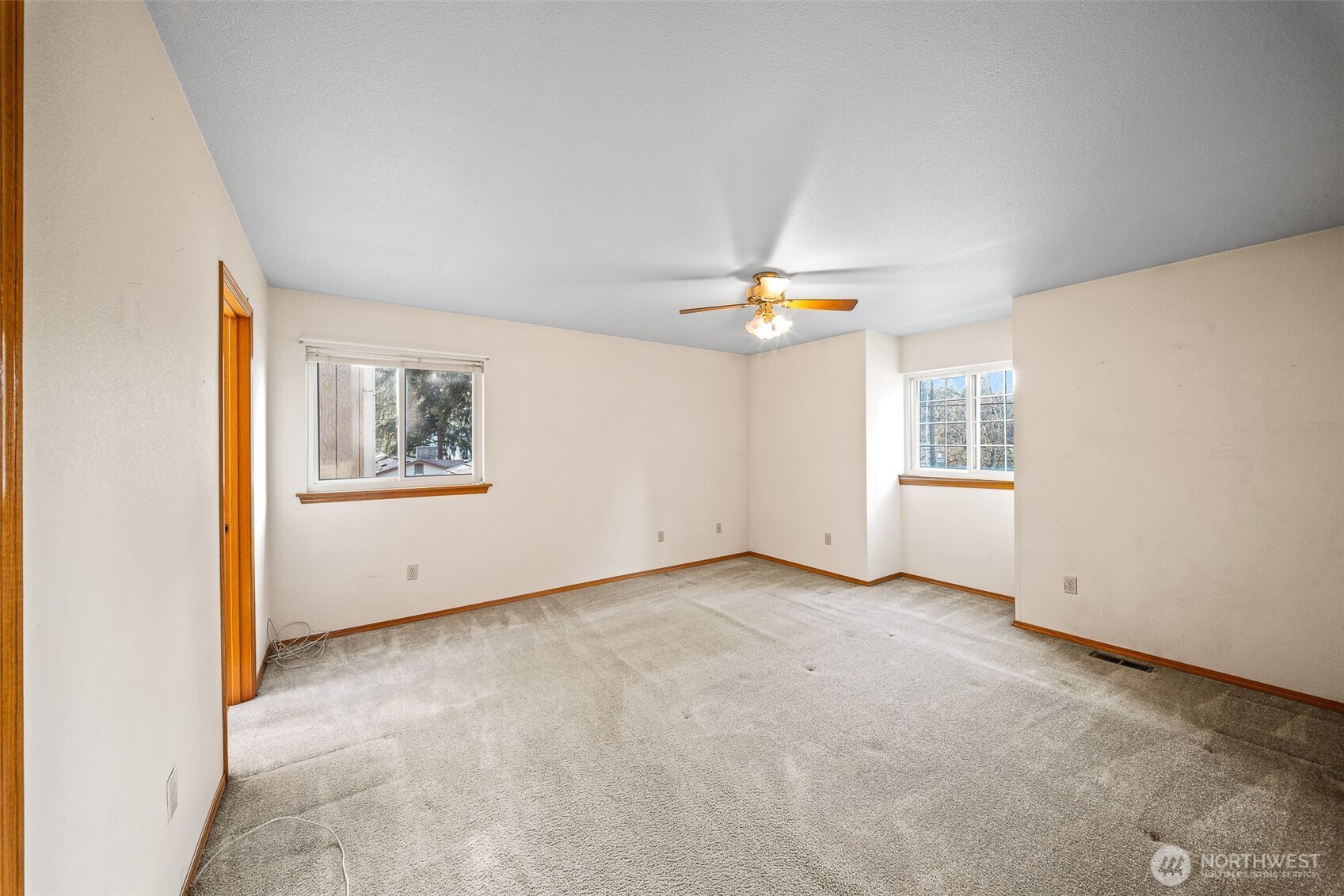 16011 Spanaway Loop Road South Spanaway, WA 98387 - Photo 17 of 35 an empty room with a view of kitchen and chandelier