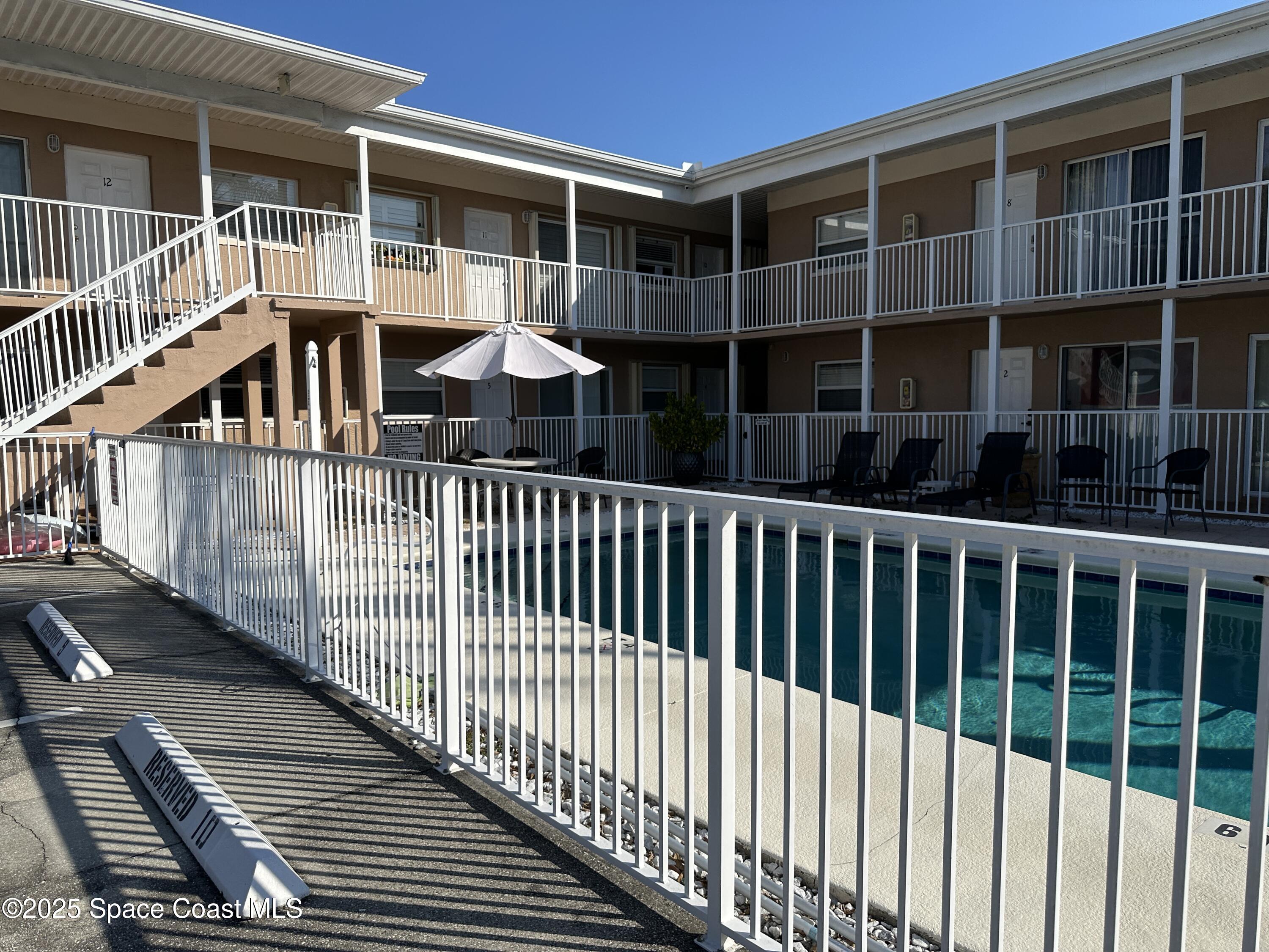a view of a balcony with a floor to ceiling window and wooden floor