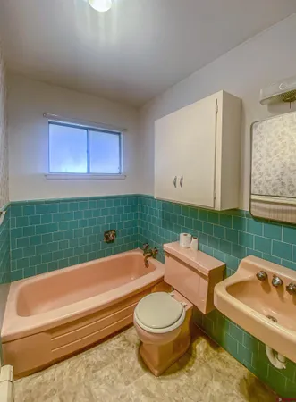 a bathroom with a toilet sink and mirror