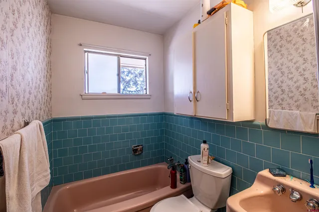 a bathroom with a toilet a sink and bathtub