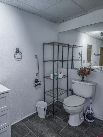 a white toilet sitting next to a bathroom sink
