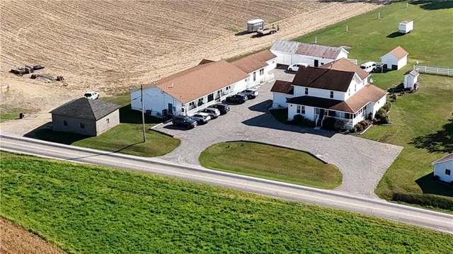 an aerial view of a house with swimming pool and patio