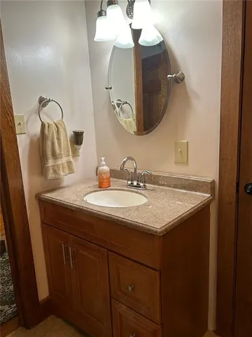 a bedroom with a bed and a view of kitchen