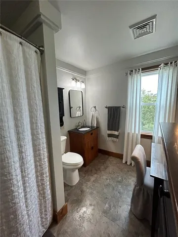 a living room with a furniture and a refrigerator