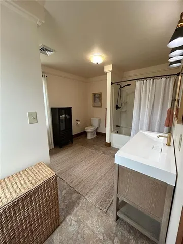 a view of a bedroom with a furniture and closet