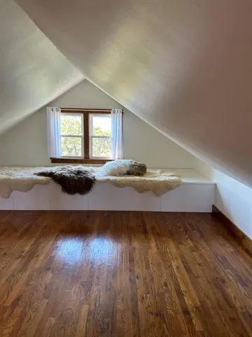 a view of a room with wooden floor