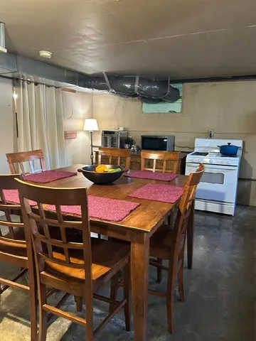 a kitchen with stainless steel appliances kitchen island granite countertop a refrigerator and a stove top oven