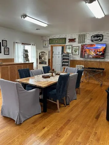 a living room with furniture a rug and a piano