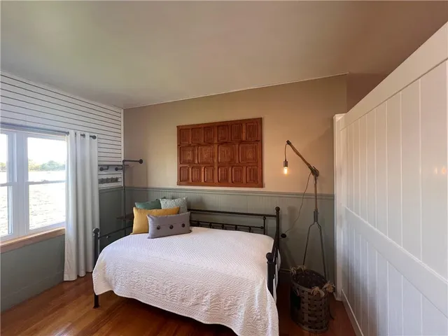 a bed sitting in a bedroom next to a window