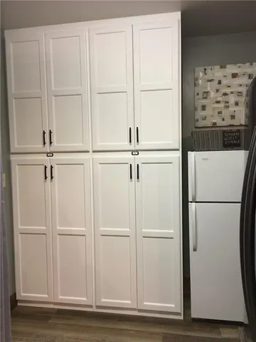 a kitchen with stainless steel appliances granite countertop a refrigerator a sink and a stove