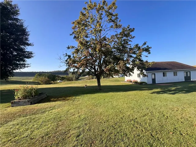 a view of a hallway with stairs and furniture