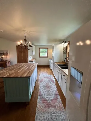 a kitchen with stainless steel appliances granite countertop a sink stove and wooden floor