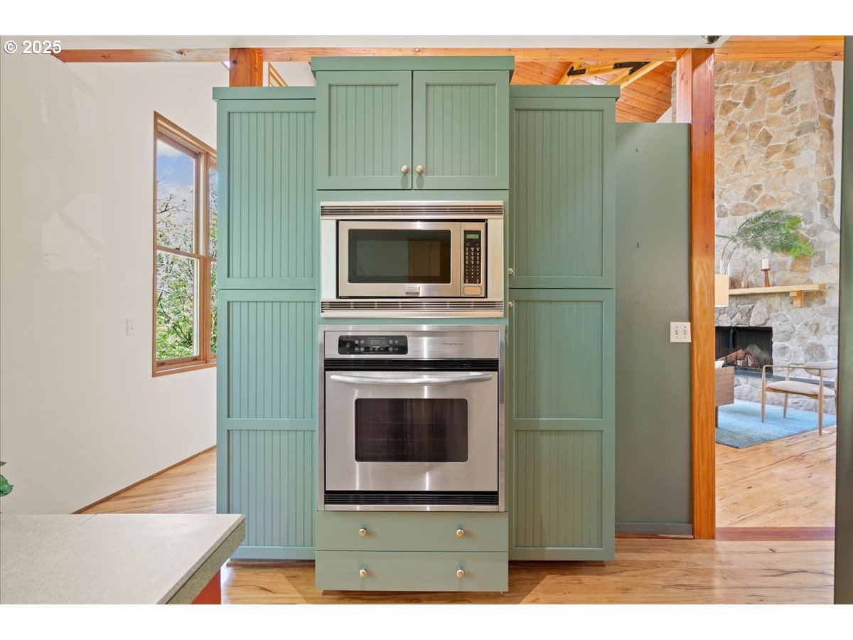 4908 Southwest Barnes Road Portland, OR 97221 - Photo 17 of 40 a kitchen with a refrigerator and a microwave